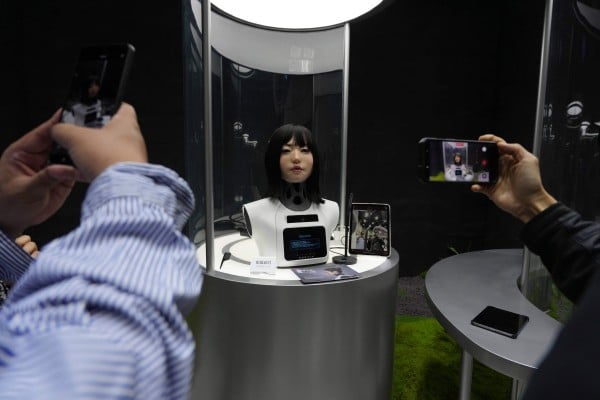 Visitors take pictures and videos of a human-like robot head on display at the Humanoid Robots Industry Base in Beijing’s Shougang Park on April 28. Photo: AP Visitors take pictures and videos of a human-like robot head on display at the Humanoid Robots Industry Base in Beijing’s Shougang Park on April 28. Photo: AP