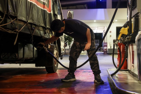 A man fills his towing lorry with diesel at a petrol station in Shah Alam, Malaysia, on May 4. Photo: EPA