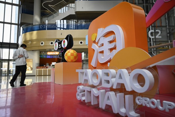 A man walks past a Taobao and Tmall installation at the Alibaba office in Beijing. Photo: AFP