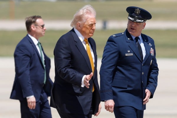 Donald Trump (centre) walks to Air Force One at Joint Base Andrews in Maryland on Tuesday en route to his meeting with Chinese President Xi Jinping. Photo: AP Donald Trump (centre) walks to Air Force One at Joint Base Andrews in Maryland on Tuesday en route to his meeting with Chinese President Xi Jinping. Photo: AP