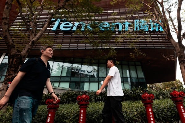 People walk in front of the Tencent headquarters building in Shenzhen. Photo: EPA People walk in front of the Tencent headquarters building in Shenzhen. Photo: EPA