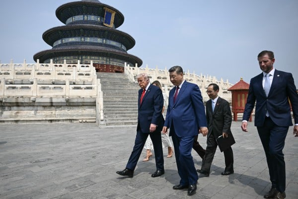 China’s President Xi Jinping (C), US President Donald Trump (L) and Eric Trump (R) visit the Temple of Heaven in Beijing on May 14, 2026. Xi warned Trump that the issue of Taiwan could push their two countries into “conflict” if mishandled, a stark opening salvo as a superpower summit set to tackle numerous thorny issues began in Beijing on May 14. (Photo by Brendan SMIALOWSKI / POOL / AFP)