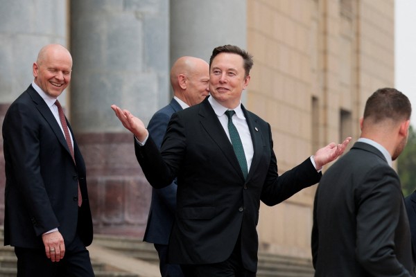 Billionaire Elon Musk gestures after attending a welcome ceremony for US President Donald Trump with President Xi Jinping at the Great Hall of the People in Beijing on Thursday. Photo: Reuters