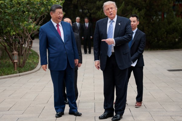 US President Donald Trump gestures towards Chinese President Xi Jinping during a visit to gardens in the Zhongnanhai leadership compound in Beijing. Photo: Reuters