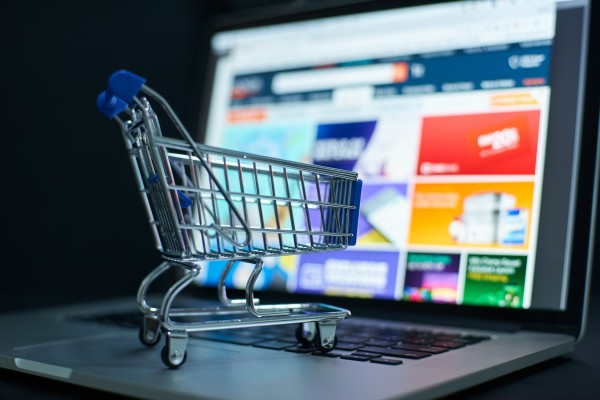 Small shopping cart on a laptop keyboard signifies convenience in digital purchases. Photo: Shutterstock Images