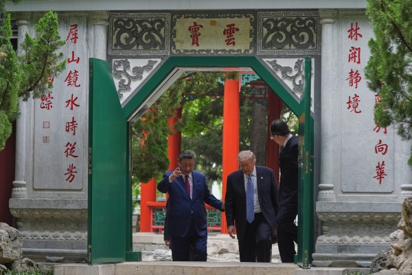Chinese President Xi Jinping leads US counterpart Donald Trump through the Yundou Gate, inscribed with couplets from the Qianlong Emperor, inside the Zhongnanhai compound in Beijing on Friday. Photo: AP