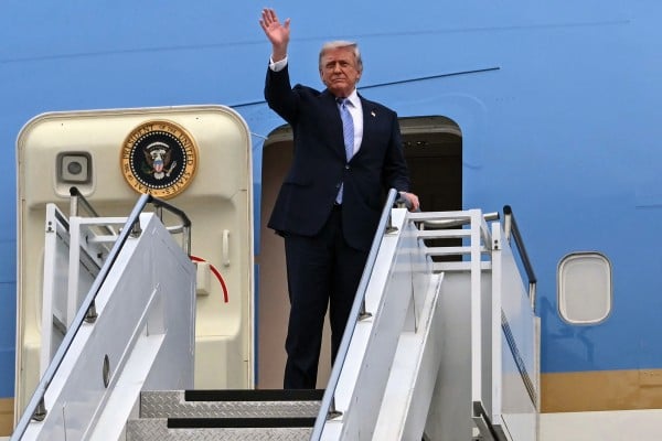 US President Donald Trump boards Air Force One before departing Beijing on Friday. Photo: AFP/Getty Images/TNS US President Donald Trump boards Air Force One before departing Beijing on Friday. Photo: AFP/Getty Images/TNS