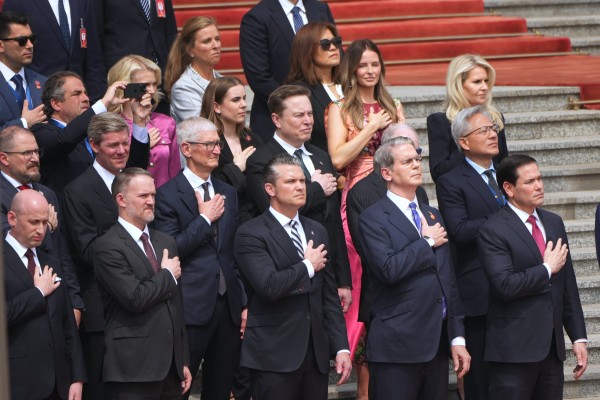 Members of the US delegation listen to the American national anthem as President Donald Trump takes part in a welcome ceremony with Chinese President Xi Jinping at the Great Hall of the People in Beijing on May 14. Photo: AP