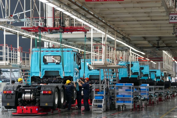 Workers at a Sany new energy heavy truck factory in Changsha, Hunan province, on May 12. A new truck rolls off the production line every six minutes. Photo: Xinhua