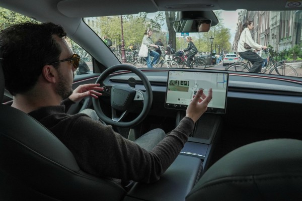 A Tesla owner drives hands-free in Amsterdam on April 17, days after Dutch regulators approved the use of the company’s self-driving software. Photo: Reuters