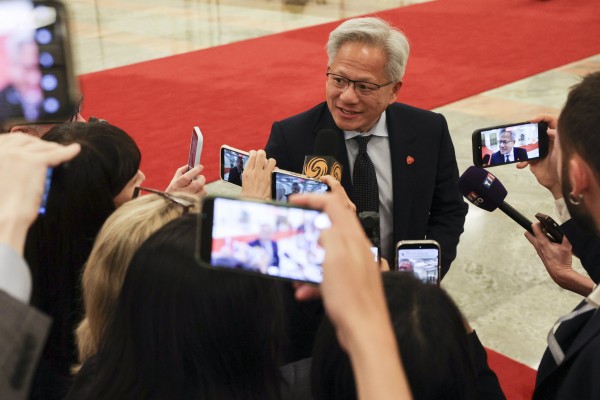 Nvidia CEO Jensen Huang speaks to reporters as he arrives at the Great Hall of the People in Beijing on May 14 for a meeting between Premier Li Qiang and US business representatives. Photo: EPA