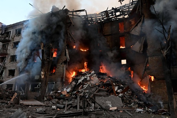 Firefighters work at the scene of a fire in a destroyed block of flats following a Russian missile attack in Kyiv, Ukraine on Sunday. Photo: SOPA Images via ZUMA Press Wire / dpa