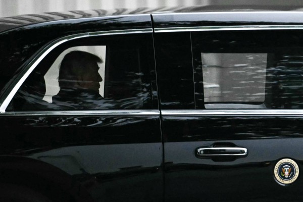 US President Donald Trump rides in his motorcade as he leaves Walter Reed National Military Medical Centre on Tuesday. Photo: AFP
