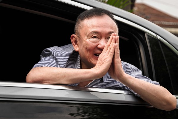 Former Thai prime minister Thaksin Shinawatra thanks supporters upon arriving back home after his release from Klong Prem Central Prison in Bangkok on May 11. Photo: AFP
