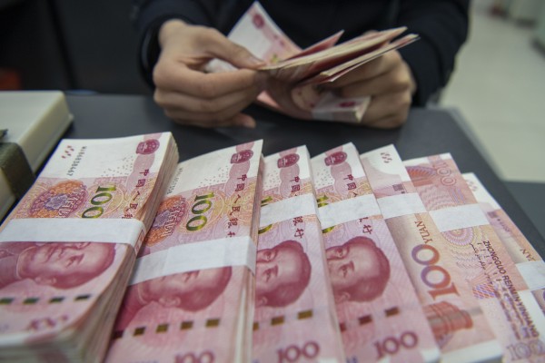 HAIAN, CHINA - MARCH 20, 2024 - A staff member counts Chinese yuan at a bank in Haian, East China’s Jiangsu province, March 20, 2024. (Photo credit should read CFOTO/Future Publishing via Getty Images)