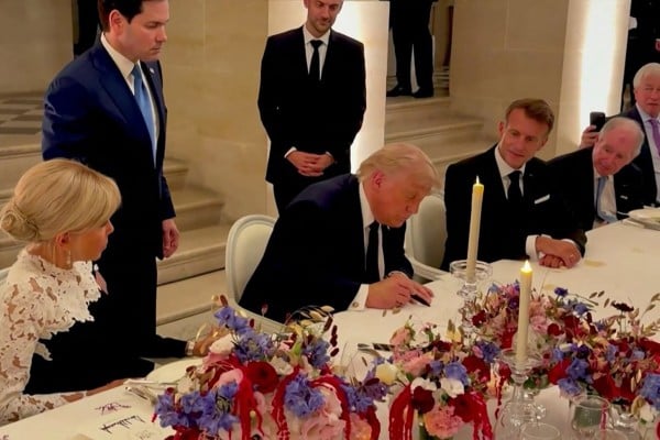 US President Donald Trump (centre) signs a memorandum of understanding with Iran in Versailles, France on June 17 as French President Emmanuel Macron (right) and his wife Brigitte Macron (left) look on. Photo: AFP and X/Scavino47 US President Donald Trump (centre) signs a memorandum of understanding with Iran in Versailles, France on June 17 as French President Emmanuel Macron (right) and his wife Brigitte Macron (left) look on. Photo: AFP and X/Scavino47