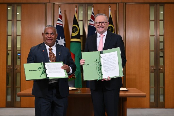 Vanuatu’s Prime Minister Jotham Napat (left) and Australian Prime Minister Anthony Albanese present the signed Nakamal agreement at  Parliament House in Canberra on Monday. Photo: EPA