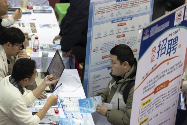 A university student inquires about employment opportunities at a recruitment fair for science and engineering universities in Harbin, Heilongjiang province, in March. Photo: Getty Images