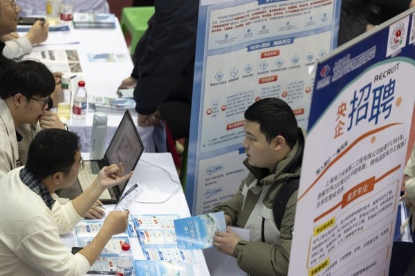 A university student inquires about employment opportunities at a recruitment fair for science and engineering universities in Harbin, Heilongjiang province, in March. Photo: Getty Images A university student inquires about employment opportunities at a recruitment fair for science and engineering universities in Harbin, Heilongjiang province, in March. Photo: Getty Images