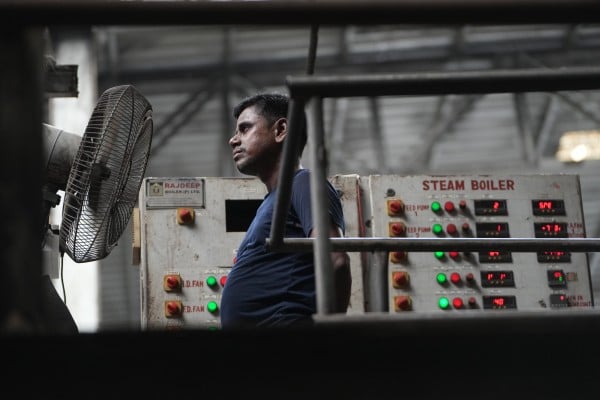 A worker stands in front of a fan on a hot day at a plant near Surat, India, on May 26. Photo: AP A worker stands in front of a fan on a hot day at a plant near Surat, India, on May 26. Photo: AP