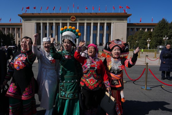 Ethnic minority delegates leave the Great Hall of the People following asession of the National People’s Congress, China’s top legislative body, in Beijing on March 9. Photo: AP