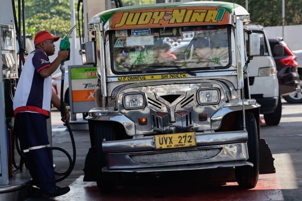 A petrol station worker prepares to refuel a jeepney in Quezon City, the Philippines, in March. Photo: EPA A petrol station worker prepares to refuel a jeepney in Quezon City, the Philippines, in March. Photo: EPA