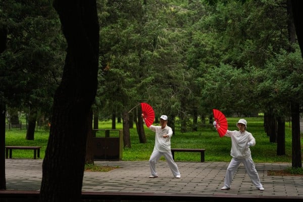 An elderly couple practice tai chi at a park in Beijing. Photo: AP An elderly couple practice tai chi at a park in Beijing. Photo: AP