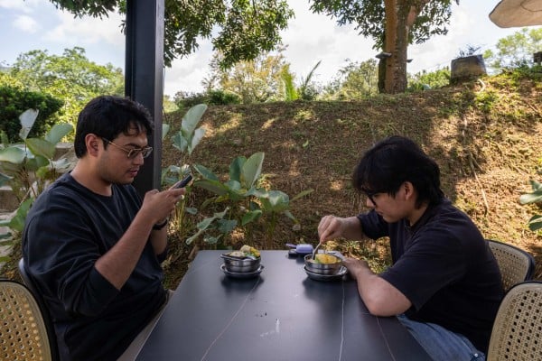 Customers eat Musang King durian desserts in Karak, Pahang, on June 27. Photo: AFP Customers eat Musang King durian desserts in Karak, Pahang, on June 27. Photo: AFP