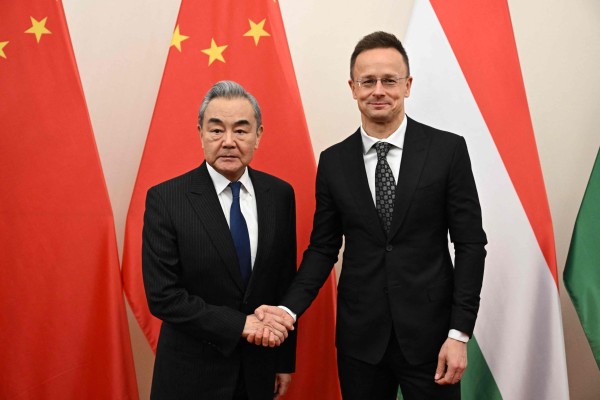 Hungary’s Peter Szijjarto, right, shakes hands with Chinese Foreign Minister Wang Yi in Budapest, Hungary on February 11. Szijjarto recently resigned as foreign minister to take an executive position at BYD. Photo: AFP