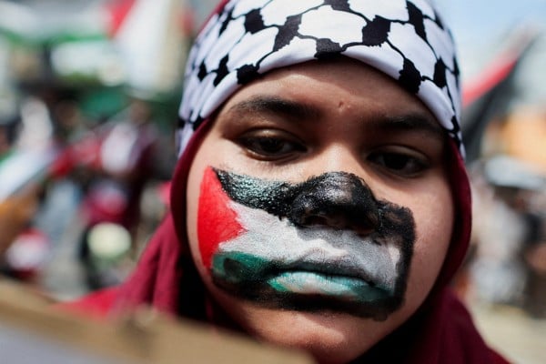 A pro-Palestinian supporter paints her face with the Palestinian flag during a march to the US Embassy in Kuala Lumpur on March 13. Photo: Reuters A pro-Palestinian supporter paints her face with the Palestinian flag during a march to the US Embassy in Kuala Lumpur on March 13. Photo: Reuters