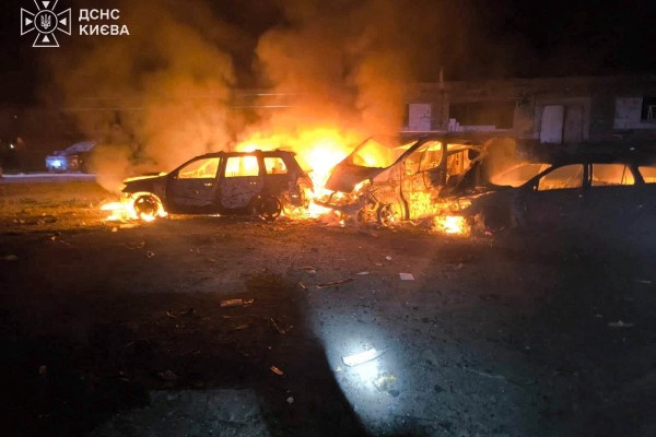 Smoke and fire rise from burning vehicles at the site of a Russian strike in a location given as Kyiv, Ukraine on Sunday. Photo: State Emergency Service of Ukraine in Kyiv Region / Handout via Reuters