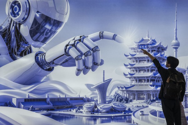 A man poses in front of a billboard showing a humanoid robot in the AI section of the China International Supply Chain Expo last month in Beijing. Photo: Getty Images