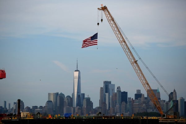 An American flag hangs from a crane at Port Liberty in Bayonne, New Jersey. US President Donald Trump slapped sweeping new tariffs on dozens of trading partners. Photo: AFP An American flag hangs from a crane at Port Liberty in Bayonne, New Jersey. US President Donald Trump slapped sweeping new tariffs on dozens of trading partners. Photo: AFP
