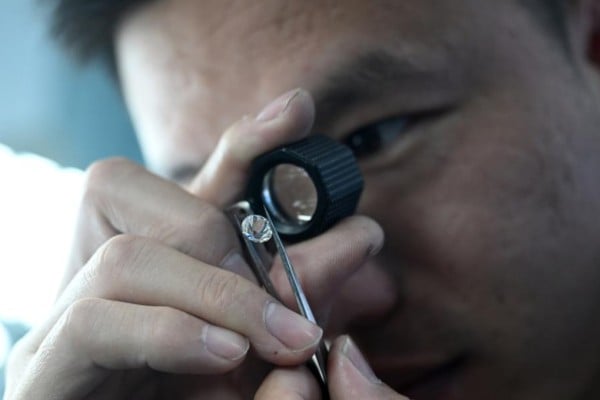 A worker checks a diamond at a facility in China’s Henan province. Photo: Xinhua A worker checks a diamond at a facility in China’s Henan province. Photo: Xinhua