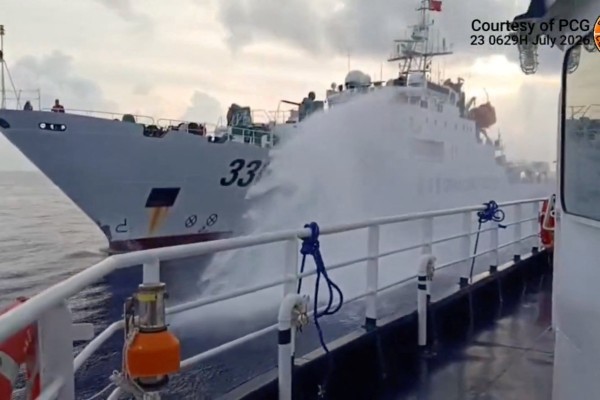 A Chinese coastguard ship fires a water cannon at a Philippine vessel in South China Sea, as seen in this screengrab of a video released on July 23. Photo: Jay Tarriela/X/Handout/Reuters  