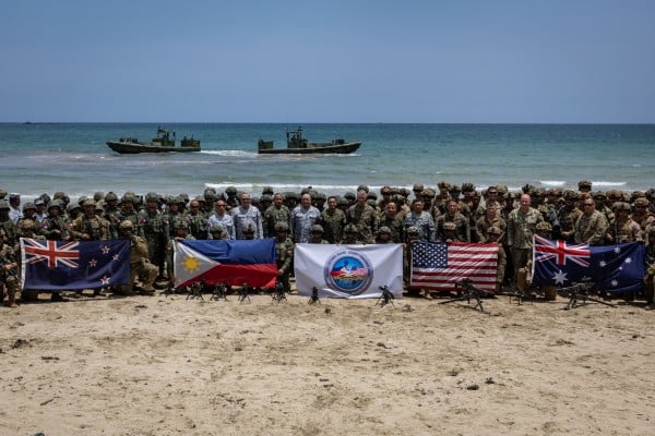 Troops from New Zealand, Philippines, the US and Australia pose with their national flags after taking part in live-fire exercises in the Philippines. Photo: Reuters