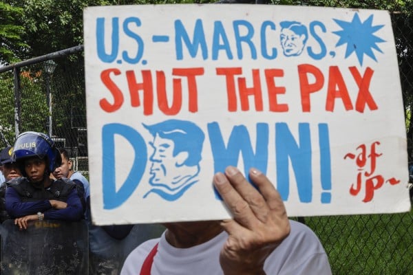 A protester holds a sign during a rally on a road leading to the US embassy in Manila on July 13, expressing opposition to Philippines-US defence agreements and the US-led Pax Silica initiative. Photo: EPA A protester holds a sign during a rally on a road leading to the US embassy in Manila on July 13, expressing opposition to Philippines-US defence agreements and the US-led Pax Silica initiative. Photo: EPA