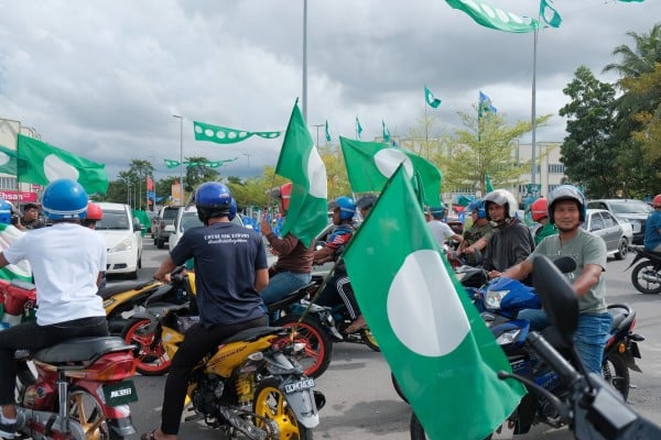 Pan-Malaysian Islamic Party supporters wave PAS flags in Kelantan ahead of the 2022 general election. Photo: Shutterstock Pan-Malaysian Islamic Party supporters wave PAS flags in Kelantan ahead of the 2022 general election. Photo: Shutterstock