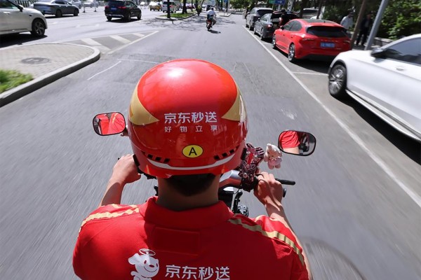 The results underscore the impact of JD.com’s expansion into food delivery, logistics and international operations over the past year. Photo: Xinhua