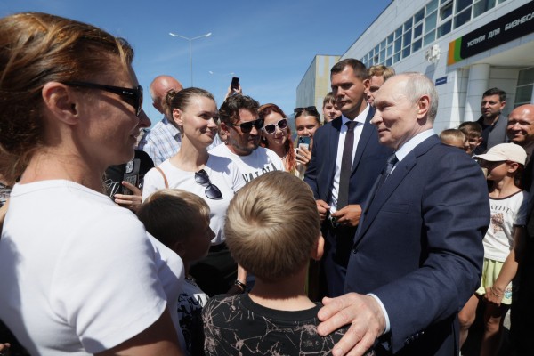 In this pool photograph distributed by the Russian state agency Sputnik, Russia’s President Vladimir Putin interacts with local residents on Iturup island, one of four islands in the contested chain known as the Kuril Islands in Russia and the Northern Territories in Japan, on August 13, 2026. (Photo by Gavriil Grigorov / POOL / AFP) In this pool photograph distributed by the Russian state agency Sputnik, Russia’s President Vladimir Putin interacts with local residents on Iturup island, one of four islands in the contested chain known as the Kuril Islands in Russia and the Northern Territories in Japan, on August 13, 2026. (Photo by Gavriil Grigorov / POOL / AFP)