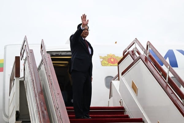 Myanmar’s President Min Aung Hlaing waves as he boards a plane bound for Russia on Monday. Photo: Myanmar’s Presidential Press and Information Bureau / AFP Myanmar’s President Min Aung Hlaing waves as he boards a plane bound for Russia on Monday. Photo: Myanmar’s Presidential Press and Information Bureau / AFP