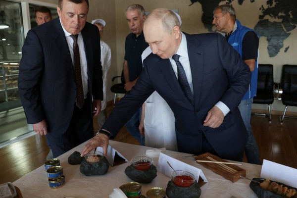 Russian President Vladimir Putin during his visit to the Yasny fish processing complex on the Kuril Island of Iturup on Thursday. Photo: Sputnik / Gavriil Grigorov / Pool via Reuters