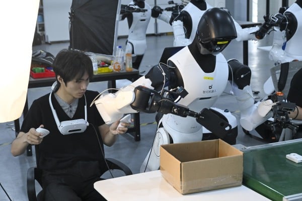 An employee programmes a robot to sort items at Maniformer, a physical AI data service platform, in Shanghai on August 5. Photo: Xinhua