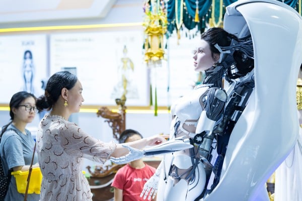 A visitor to the World Robot Conference in Beijing touches a humanoid robot on display, on August 19. Photo: China News Service via Getty Images A visitor to the World Robot Conference in Beijing touches a humanoid robot on display, on August 19. Photo: China News Service via Getty Images