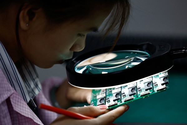 Printed circuit boards are inspected at a factory in Dongguan, Guangdong province, China. Photo: Reuters