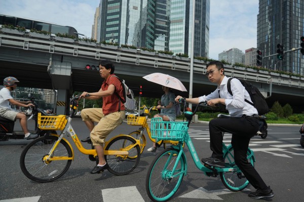 People ride bicycles on a street in Beijing. China’s leadership is looking to avoid an overreliance on strong policy stimulus while striving to reach economic growth goals. Photo: AP