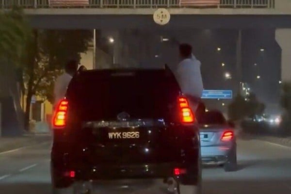 Men hang out a car and sit on the windows in Kuala Lumpur early Friday morning. Photo: Reddit/whusler