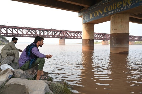 People sit on the bank of the river Chenab flowing through Chiniot, Punjab province, Pakistan, in May last year. India halted water flow from Chenab into Pakistan amid rising tensions following a terrorist attack in Kashmir. Photo: EPA-EFE People sit on the bank of the river Chenab flowing through Chiniot, Punjab province, Pakistan, in May last year. India halted water flow from Chenab into Pakistan amid rising tensions following a terrorist attack in Kashmir. Photo: EPA-EFE