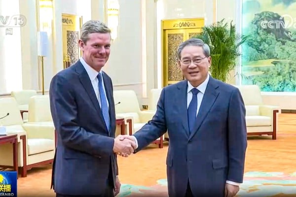 Chinese Premier Li Qiang, right, shakes hands with Visa CEO Ryan McInerney during a meeting at the Great Hall of the People in Beijing on Tuesday. Photo: CCTV