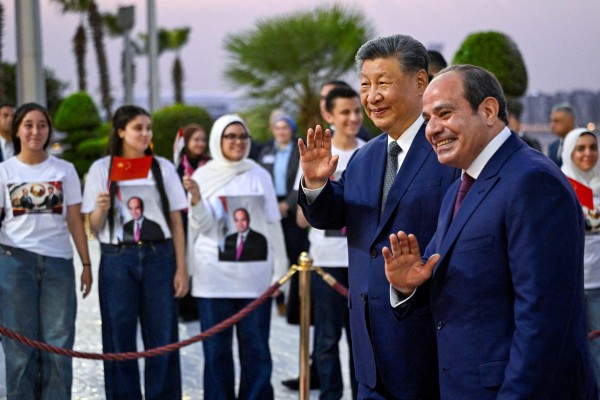 President Xi Jinping and Egyptian President Abdel-Fattah el-Sisi wave to the crowd after Xi’s arrival at Cairo International Airport on Tuesday. Photo: Reuters